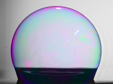 A soap bubble wetting an ultrahydrophobic surface