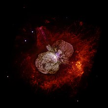 Hubble Space Telescope image showing Eta Carinae and the bipolar Homunculus Nebula which surrounds the star. The Homunculus was partly created in an eruption of Eta Carinae, the light from which reached Earth in 1843. Eta Carinae itself appears as the white patch near the center of the image, where the 2 lobes of the Homunculus touch.