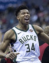 A basketball player, wearing a white jersey with the word "BUCKS" and the number 34 on the front.