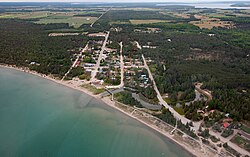 Aerial view of Central Manitoulin with Providence Bay Beach in the foreground.