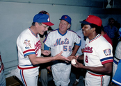 Vice President Bush prepares to sign a baseball for Tony Oliva at an Old Timers game in Denver, Colorado in 1984. Bill Monbouquette looks on.