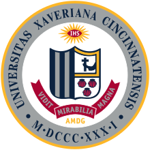 The Xavier University seal, like the St. Xavier seal, bears the schools' coat of arms, which consists of five vertical stripes, an arm holding a crucifix, and three seashells.