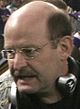 Brad Childress wearing glasses and a headset