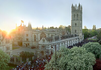 Magdalen College on May Morning. By tradition, revellers gather outside the college at 6am on 1 May (many having attended all-night balls and parties) and the college choir sings madrigals from the top of Magdalen Tower.
