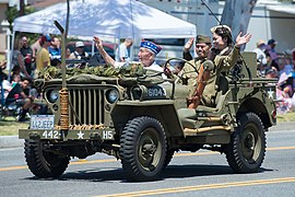 Japanese American WW II veterans in jeep in memorial parade