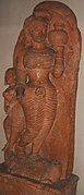 The goddess Ganga stands on her mount, the makara, with a kumbha, a full pot of water, in her hand, while an attendant holds a parasol over her. Terracotta, Ahichatra, Uttar Pradesh, Gupta, 5th century, now in National Museum, New Delhi