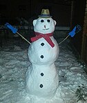 Snowman with hat, scarf, and winter gloves in Germany