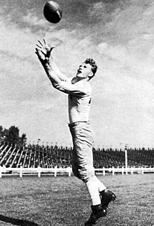Black and white photo of Don Hutson catching a football