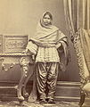 Girl from Karachi, Sind, in narrow Sindhi Soossi suthan and cholo. c. 1870.