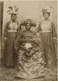 Ovonramwen, Oba of Benin and his wives Queen Egbe (on the left) and Queen Aighobahi (on the right)