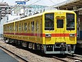 Two-car set 8575 in experimental yellow and orange livery in July 2017