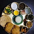 South Indian meal served in traditional bronzeware thali
