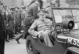 Winston Churchill in a jeep at the Reichstag building touring the ruins of Berlin, 16 July 1945