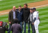 Randy Johnson in a black suit. To his left is Jay Buhner and Dan Wilson. To his right is Edgar Martínez and Ken Griffey Jr.