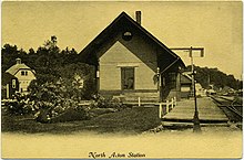 A postcard photo of a small railroad station