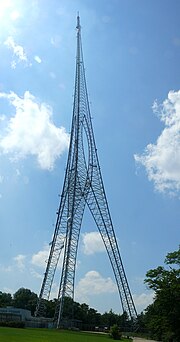 A dark-colored telecommunications tower with an unusual design