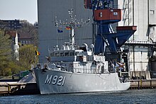 A military style ship with Belgian Flag on a port