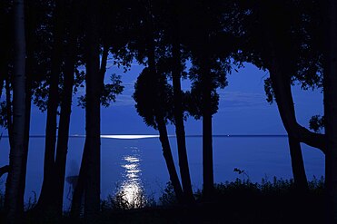 Night photo of moon light on peaceful Lake Michigan