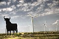 Osborne bull near a wind farm in La Muela, Zaragoza