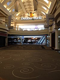 A concourse of Forest Fair Village shopping mall, showing the entrance to Bass Pro Shops.