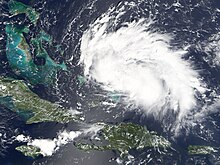 Satellite image of a rather weak tropical cyclone - the storm is an elongated mass of clouds, stretching horizontally.