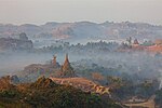 Foggy view of ruins of religious buildings in a forest