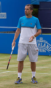 Jose Clavet coaching Feliciano López during practice at the Queens Club Aegon Championships in London, England.