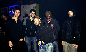The 5 members of Stateless posing side-by-side on a dark background.