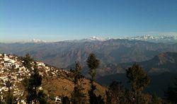 A view of the left half of the Gangotri Group in the Western Himalayas from Pauri, part of which is seen on the left. Pauri City as viewed from adjacent hill.