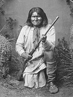 Geronimo (Goyaałé), a Bedonkohe Apache; kneeling with rifle, 1887.