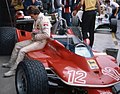 Gilles Villeneuve sitting beside the Ferrari 312T at the 1979 Dino Ferrari Grand Prix. Just like in previous seasons, the Scuderia Ferrari livery included Goodyear and Agip as their sponsors