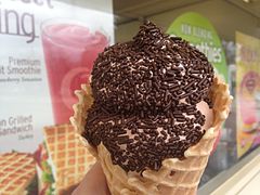 Chocolate soft-serve ice cream with sprinkles in a waffle cone from Dairy Queen