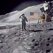 David Scott salutes the American flag during the Apollo 15 mission. The arms of the crosshair are washed-out on the white stripes of the flag (Photo ID: AS15-88-11863).