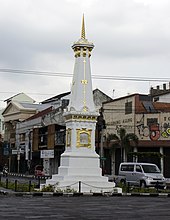 White monument at an intersection
