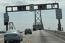 Electronic signs indicate vehicles are moving the correct direction on the bridge