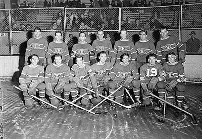 1942 Montreal Canadiens posing for photo on rink. First row of seven players kneeling and the second row of seven players standing behind.