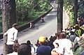TT race spectators at the exit to Glen Helen in 1969 with two travelling marshals passing by towards Creg Willey's Hill