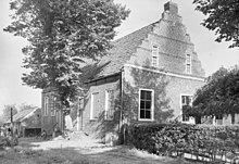 Black and white photo of the building exterior and a tree in 1938
