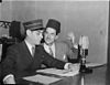 Rene Lecavalier on the right speaking to a colleague to his right on a 1947 radio program