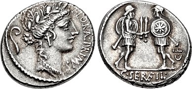 Denarius of Gaius Servilius, 53 BC. The obverse features the head of Flora with a lituus behind, the reverse the duellists facing each other and presenting swords.[13] The emblem on the shield of the right soldier could be the Vergina Sun, thus alluding to an event of the Macedonian Wars.
