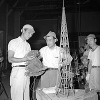 Tsuburaya (center) and director Ishirō Honda (holding Godzilla puppet) on the set of Godzilla (1954)