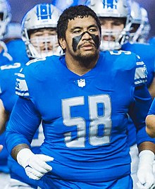 Penei Sewell from the waist up in a Lions uniform and no helmet wearing eye black.