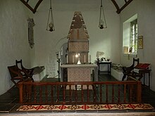 View of the chancel, with Melangell's shrine and the altar at the centre. The two effigies are visible on either side, and the door to the grave chapel is visible in the back.