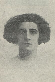 image of a woman with short wavy hair and a serious expression