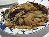 Beef chow fun (乾炒牛河) is a staple in Cantonese cuisine.