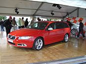 Front drivers side view of red V70 R-Design with matte silver trim, mirror caps and foglight surrounds