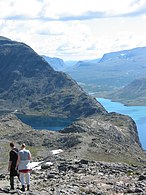 Hikers along Besseggen seen towards east, with Gjende on the right and Bessvatnet on the left