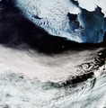 In the top-right corner of the image is Alaska's mainland blanketed with snow, as well as Nunivak Island. At the centre of the image are the islands of Saint Paul and Saint George – part of the Pribilof Islands. Also note the von Kármán vortex street (swirly clouds) in the middle right.