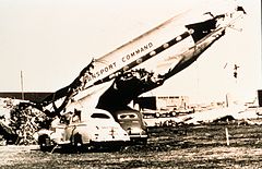 Destroyed plane and two damaged cars