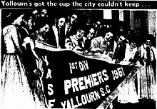 Yallourn Soccer Club holding the pennant for winning the 1951 Victoria State Championship